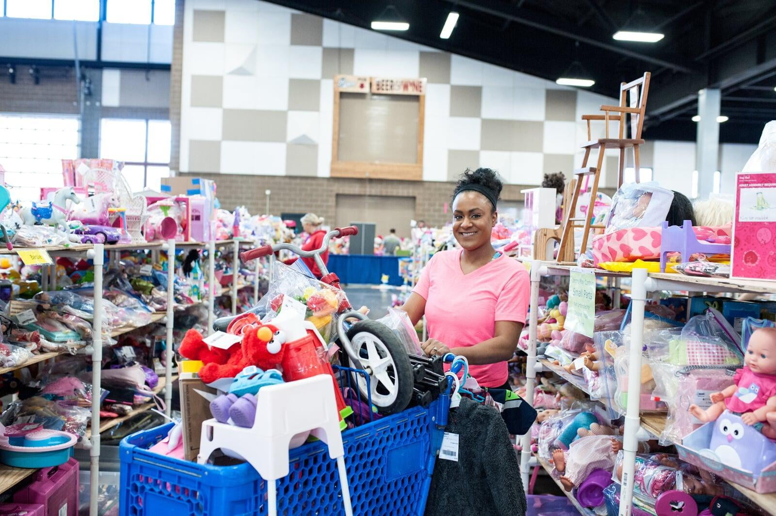 A masked Team Member with gloves helps out at a local JBF sale.